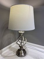 Front view of the lamp showing its full height, fabric shade, and twisted metal base.