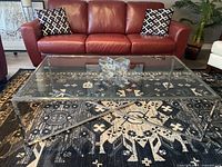 Full front view of the rectangular glass coffee table with chrome frame