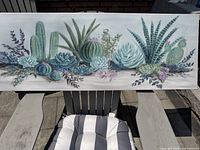 Full view of wooden rectangular wall art with detailed succulent and cactus painting in muted colors.