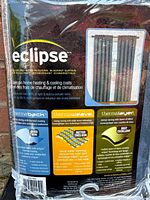 Photo of the front of the packaged curtain with brand name 'Eclipse' and energy-saving blackout curtain details.