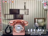Box front showing the GPO 746 Classic Rotary Telephone in a metallic rose-gold color, rotary dial, and handset with coiled cord.