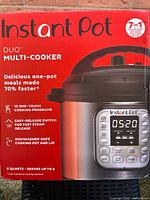 Front label of Instant Pot Duo Multi-Cooker box showing product name, capacity, and features including 13 one-touch cooking programs and dishwasher safe pot and lid.