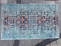 Top-down view of rectangular blue multi-color patterned rug manufactured by Safavieh.