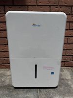 Front view of white Senville dehumidifier showing logo and water level window.