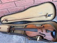 Violin, bow, and case laid open showing entire contents