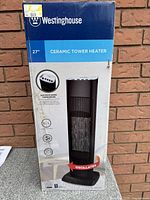 Front view of the Westinghouse ceramic tower heater box showing product image and features.