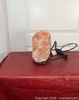 Front view showing the entire medium-sized Himalayan salt lamp with base and power cord.