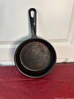 Top view of the 9-inch cast iron skillet showing the inner cooking surface with light rust and signs of wear.