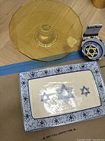 Photo showing the glass cake stand and Jewish trays, close-up view of Star of David designs on the trays