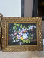Front view of the flower framed art by H. Petti showcasing brightly colored flowers in detailed brushwork with ornate gold frame.
