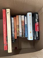 Photo showing 11 books in a box, titles visible.
