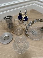 Overview of various kitchen items including glass pitcher, glass dishes, ceramic bottles, and metal salt and pepper holder.