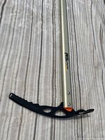 Close-up of the pick and shaft showing Petzl Omnidrice branding and black pick with serrated teeth and adze