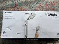 Box front of Kohler Raindet 3-in-1 Multifunction Shower System in vibrant brushed nickel finish.