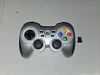 Front view of the Logitech wireless gamepad showing buttons, analog sticks, and D-pad.