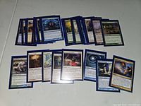 Photo showing some of the Magic: The Gathering cards individually sleeved and arranged showing front art and card text.