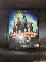Front cover of Pandemic board game box showing illustrated characters and title