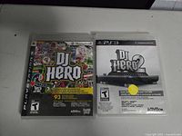 Front covers of DJ Hero and DJ Hero 2 Playstation 3 games showing case artwork and titles.