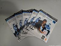 Five sealed PlayStation 3 Move demo discs arranged fanned out showing the front cover art featuring a man holding the Move controller.