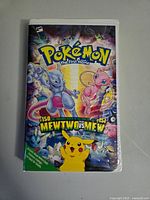 Front cover of the VHS tape showing Pokemon The First Movie artwork with Mewtwo, Mew, Pikachu and other Pokemon characters.