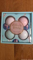 Four pastel-colored bath bombs in original light blue box labeled 'Bathing Beauties'