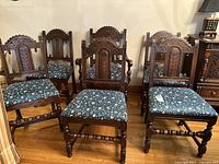 Set of six carved oak chairs arranged, showing overall style and condition