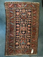 Full view of rectangular rug laid flat on carpet
