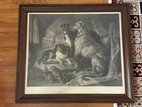 Full view of antique framed black and white print showing three dogs and a parrot in an interior setting.