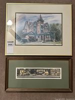 Two framed artworks: a larger watercolour above and a long panoramic print below, both hung on a wall.