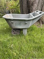 Side view of the easy roller plastic wheelbarrow showing the body, single rear leg and one front wheel.