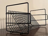 Side angle showing the angled slots for holding records or CDs in the black metal rack