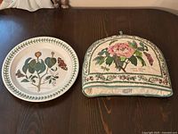 Full set on table showing plate and tea cozy