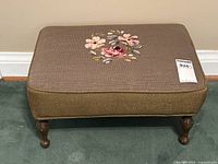 Top view showing brown needlepoint fabric with multicolor floral design