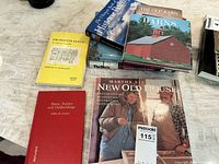 Books laid out on table showing titles and cover images including Martha Stewart's New Old House and red hardcover Barns, Stables and Outbuildings.