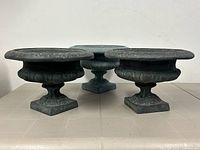 Three identical fibreglass urns displayed side by side, showing overall size and shape