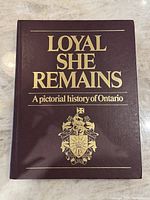 Front cover of the book showing title and gold embossed emblem.