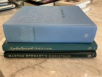 Stacked spines of the three Martha Stewart cookbooks showing titles and colors
