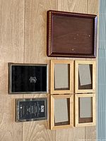 Top view showing five wooden frames (four 4x6, one 8x10) and two silver plated frames (one 5x7 with a branded backing).