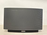 Front view of black Sonos Play:5 speaker showing curved metal grille and Sonos logo