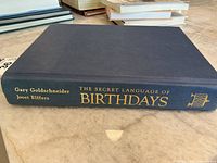 Side view of the closed, hardcover book showing the title and authors on the spine.