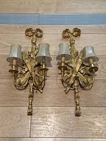 Both sconces laid flat on floor showing full front view