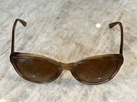 Front view of the light brown Tod's sunglasses showing oval shaped lenses and translucent frame