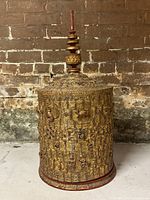 Front view of cylindrical betel box with lid and finial