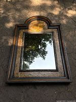 Full view of the large antique-style mirror showing the hand-painted wood frame and reflection.