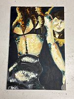 Front view of the unframed modern abstract oil painting depicting a woman with curly hair and another profile face.