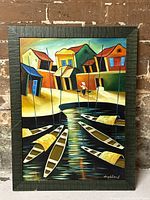 Full view of signed acrylic painting of fishing village with colorful houses and boats on water.