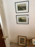 Three framed landscape prints displayed on a wall and floor, showing their size and frame style.