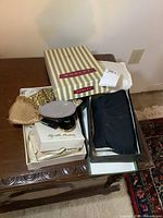 Display of Morley striped box with vintage purses and boxes placed on wooden table
