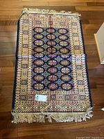 Full view of the rug showing overall pattern and size on hardwood floor