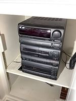 Side view and full front view of the Sony mini stereo tower system showing stacked units with CD changer, cassette decks, and tuner.